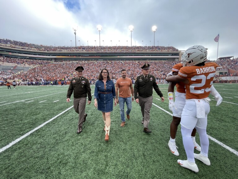 Dr. Borah leaving the field after the longhorns coin toss