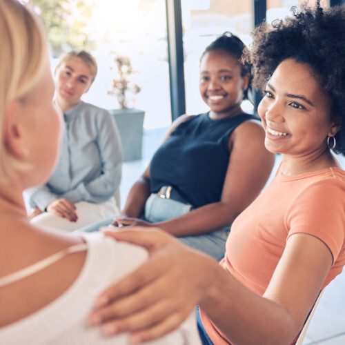 Support group of women - placing hand on shoulder